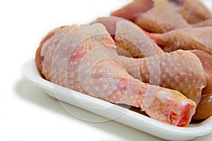 Detail of chicken leg on plastic plate