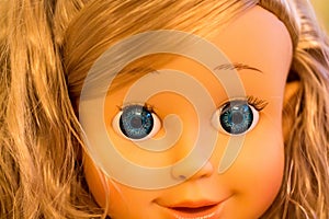 Detail children doll face with blue eyes and blond hair