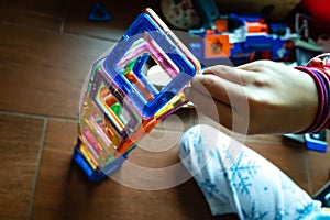 Detail of children playing with pieces of blocks to entertain