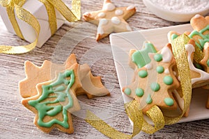 Detail of Christmas cookies decorated with icing and ribbon elevated
