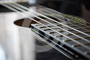 Detail of classic acoustic guitar with shallow DOF and blur.