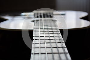 Detail of classic acoustic guitar with shallow DOF and blur.