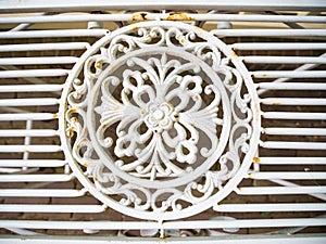 Detail of classic vintage ornament as decoration in cast iron white chair