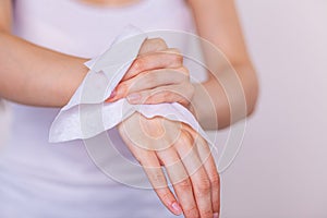 Detail of cleaning hands with wet wipes