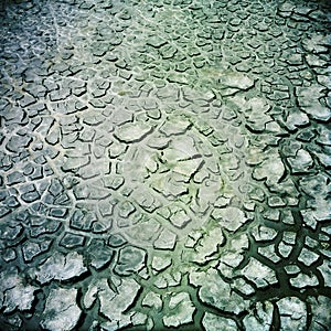 Detail close up of cracked soil exposed on the tidal zone