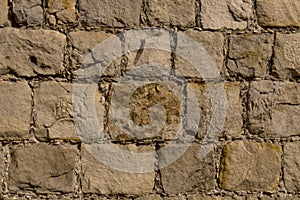 Detail closeup evenly bricked sandstone wall background