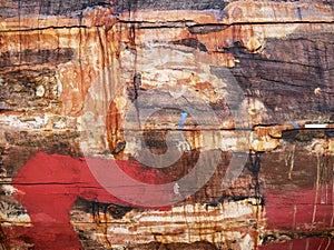 Detail and closeup of old and colored boat wooden hull, old painting with cracks and wood texture