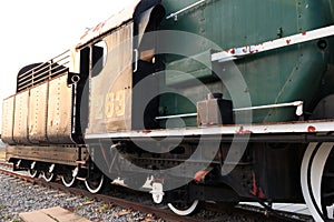 A detail closeup of a steam locomotive releasing steam. Vintage train.