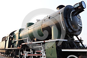 A detail closeup of a steam locomotive releasing steam. Vintage train.