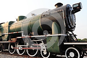 A detail closeup of a steam locomotive releasing steam. Vintage train.