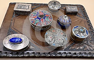 Detail of a collection of pillboxes or small boxes.