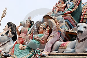 Detail of the colored wood statue on the roof of the Sri Mariamman Hindu temple in Chinatown Singapore