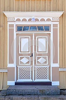 The detail of colorful decorated historic wooden entrance door of old house in Sweden