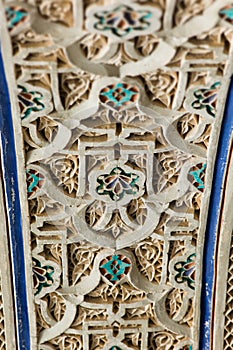 Detail of colorful decorative ceramic tiles in a door arch of the Bahia Palace in Marrakesh, Morocco
