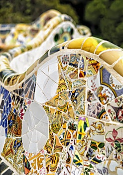 Detail of colorful mosaic work on the main terrace of Park Guell. In 1984 UNESCO declared the park a World Heritage Site under Wor