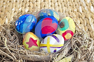 Detail of colorful painted Easter eggs placed in a wooden nest