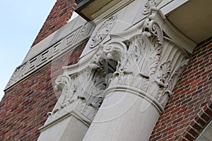 Detail of column capitals against a brick wall