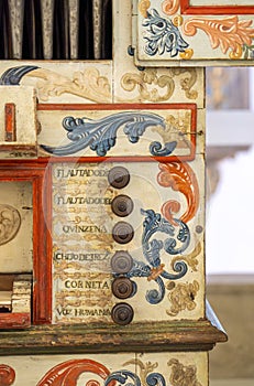 Detail of commands and buttons of a restored organ decorated with painted floral motifs from the Church of San Francisco.