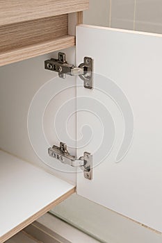 Detail of concealed hinge on cabinet door