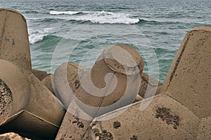 Detail of concrete water breakers in front of wave
