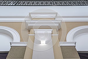 Detail of corner ceiling with intricate crown molding on column with spot light