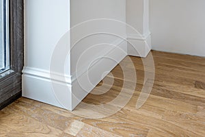 Detail of corner flooring with intricate crown molding and plinth