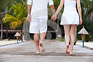 Detail Of Couple Walking On Wooden Jetty