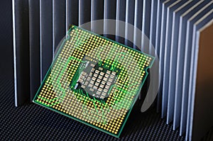 detail of cpu chip processor on aluminum heat sink cooler and electronic circuit effects.