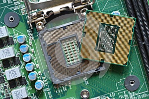 Detail of a CPU Processor over his Socket on a Motherboard. Printed Circuit Board - Computer Motherboard with Components. Close-up