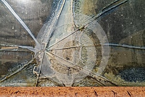 Detail of a crack in the window of an antique panel truck