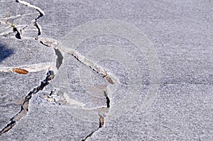 Detail of cracked cement sidewalk photo