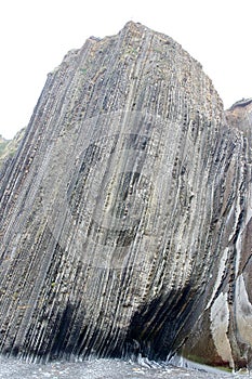 Detail of crazy rock formations geological phenomena called flysch to be found in Itzurun beach, Zumaia, Spain.