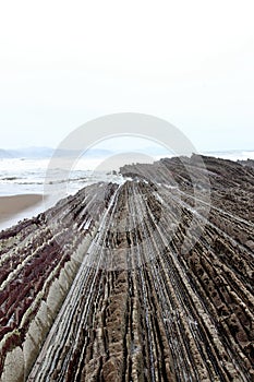 Detail of crazy rock formations geological phenomena called flysch to be found in Itzurun beach, Zumaia, Spain.