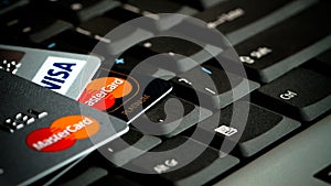 Detail of credit cards over laptop keyboard. Concept image for data breach, data security, e-commerce, credit card online use.