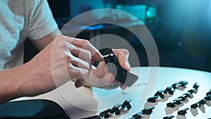 Detail cropped shot of unrecognizable man cleaning dirty space button of disassembled keyboard using cotton bud on