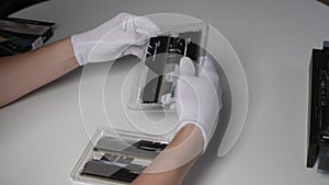 Detail cropped shot of unrecognizable man in rubber gloves pulling out the plastic blisters new 64GB 4x16GB DDR4