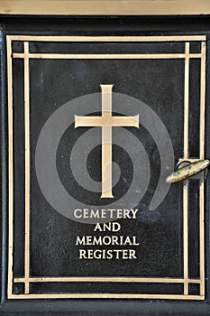 Detail of cross on tombstone in cemetery. Engraving with christian religious symbol in close up