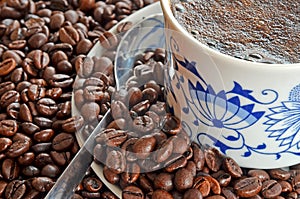 Detail of cup of coffee and pile of coffee beans