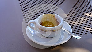 detail of cup of coffee. white cup with saucer, teaspoon. coffee break