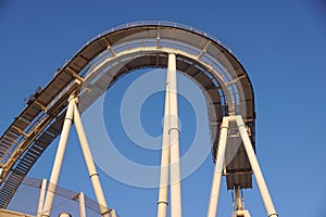 Detail of curved rollercoaster track at sunset