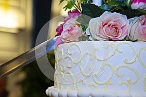 Detail of the cut by a sword of a white wedding cake