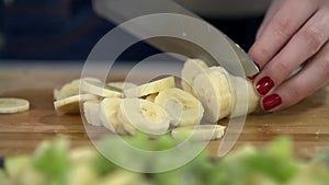 Detail of cutting banana up in slow motion