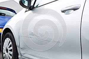 Detail Of Damage To Door Of Vehicle In Car Park With Scratched Panel