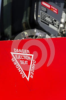 Detail of danger ejection seat warning sign on airplane photo