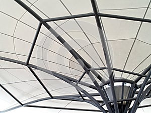 detail of dark gray metal pipe frame with white canvas roof, roof market tent decoration