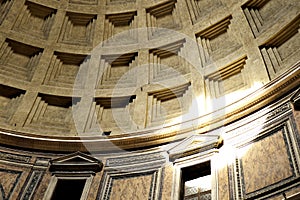 Detail of decorated concrete Dome of the Pantheon, Rome, Italy with beam of sunlight shining through the central opening (oculus) photo