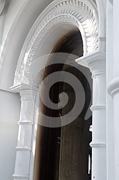 Detail of a decorative carved marble column in an Indian temple under construction