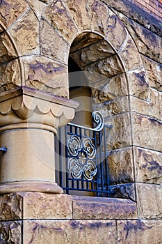 Detail of Decorative Iron Grill in Sandstone Block Arch