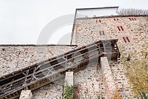 Detail of the defence system with wooden side staircase to a large watchtower on the castle wall with embrasures of the fortress F