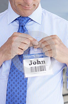 Detail Of Delegate Pinning On Name Badge At Conference